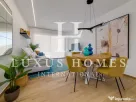 Apartament modern cu piscină comunitară și terasă, situat aproape de plajă