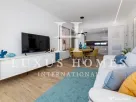 Apartament modern cu piscină comunitară și terasă, situat aproape de plajă