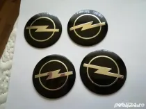 Set Capace/Embleme roți Opel diametrul 56 mm culoare pe negru