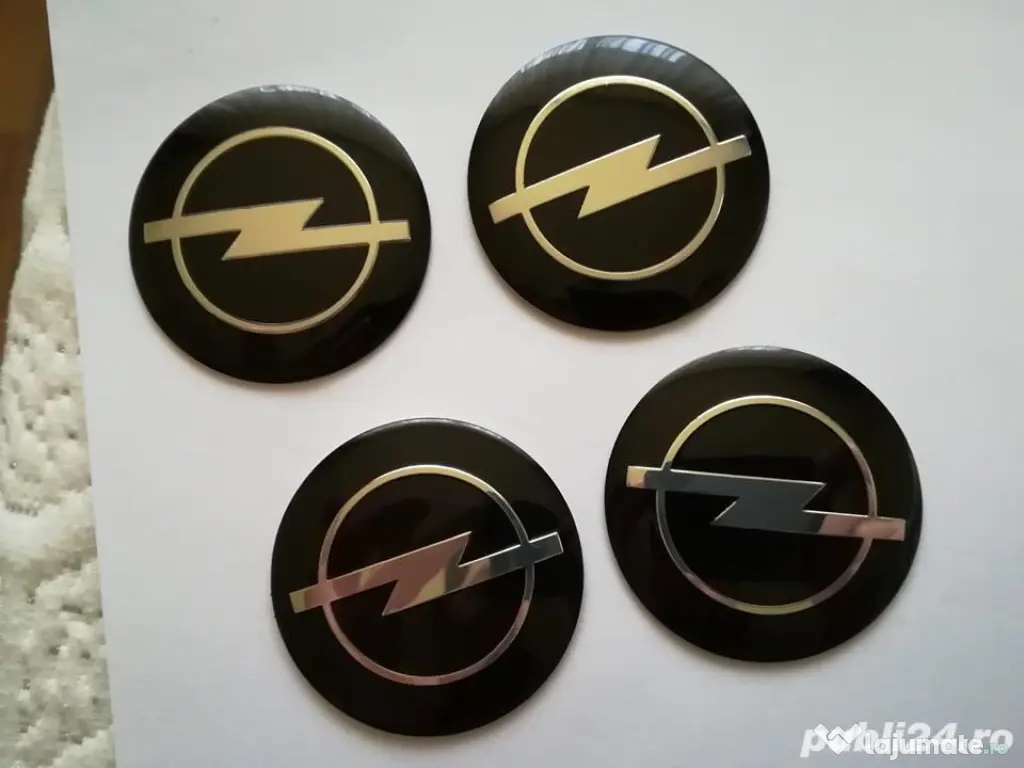 Set Capace/Embleme roți Opel diametrul 56 mm culoare pe negru 